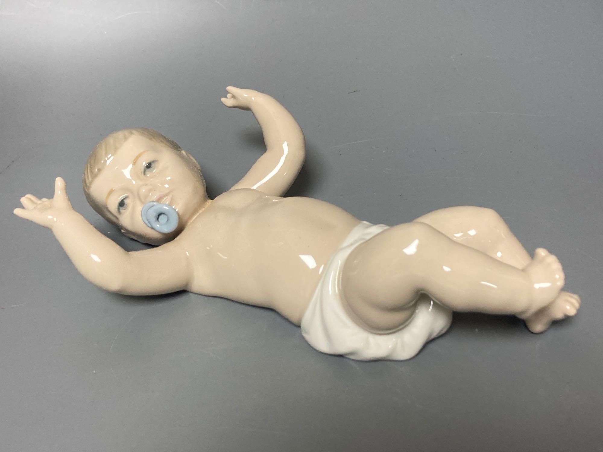 A Lladro figure of a geisha, 30cm high and another of a seagull, 29cm high and a Nao figure of a baby, length 21cm